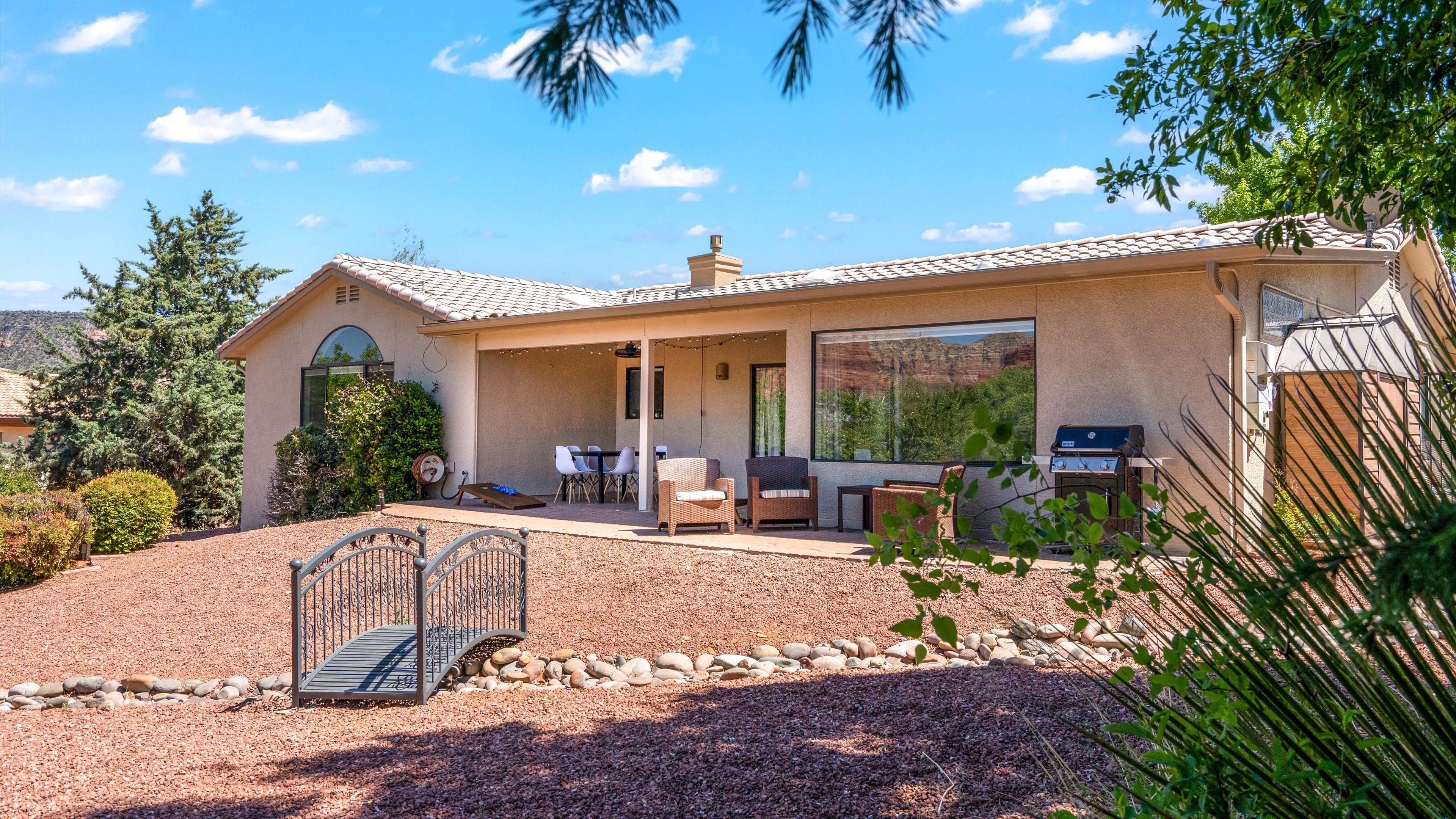 Covered patio with outdoor dining table and seating